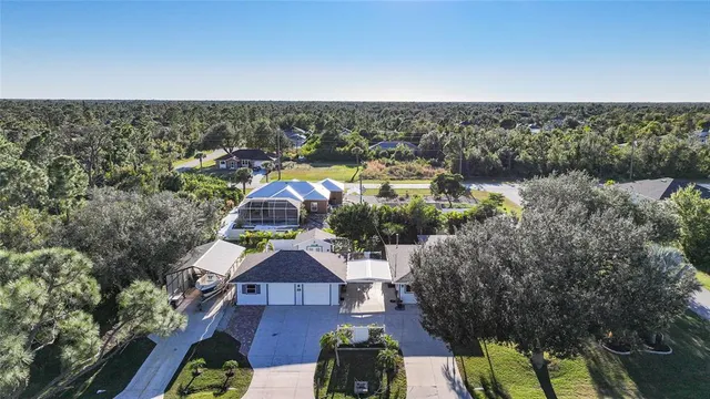 an aerial view of residential houses with outdoor space and swimming pool