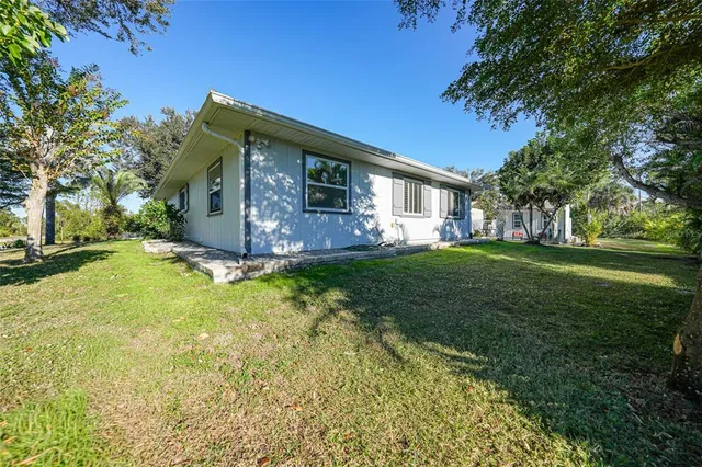 a swimming pool with outdoor seating and yard