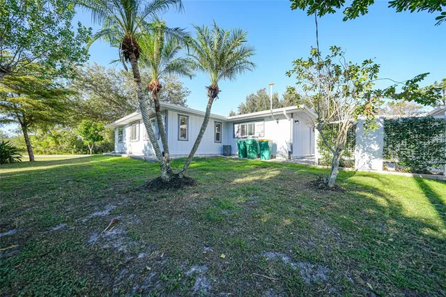 an aerial view of residential houses with outdoor space and swimming pool