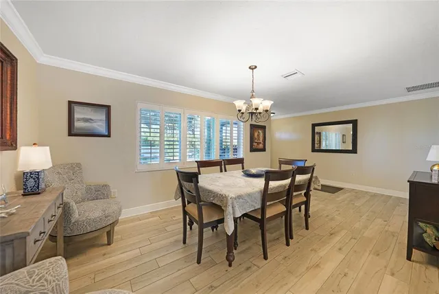 a dining room with wooden floor and furniture