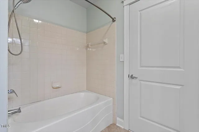a bathroom with a tub and a shower