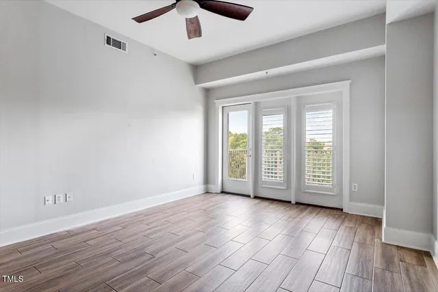 wooden floor in an empty room with a window