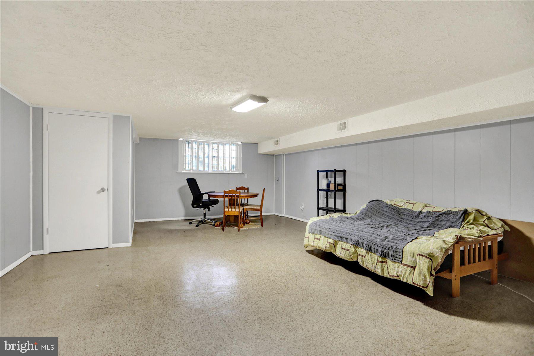 959 Elm Road Baltimore, MD 21227 - Photo 16 of 27 a spacious bedroom with a bed and furniture