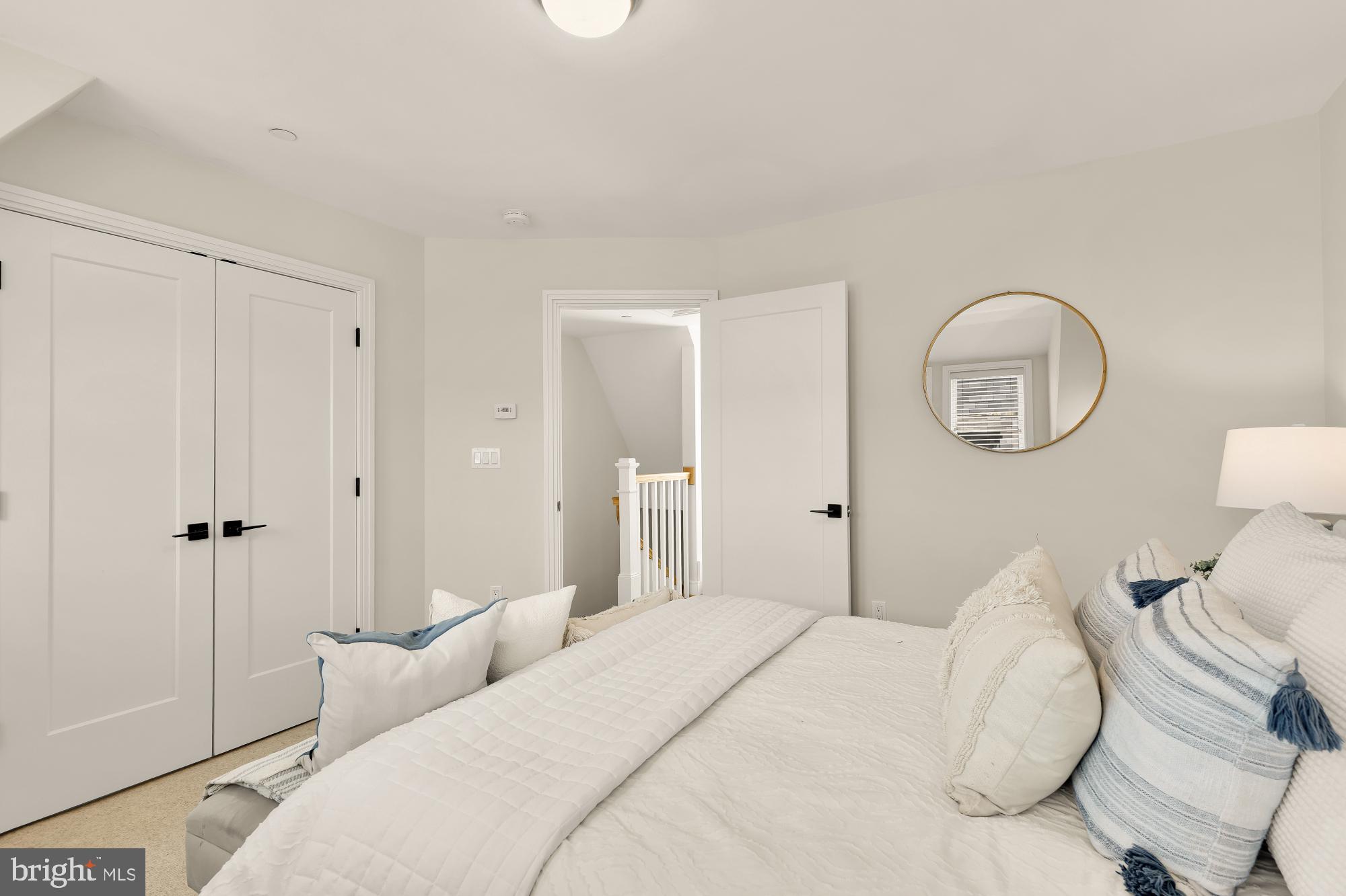 415 Guethler's Way Washington, DC 20003 - Photo 24 of 32 a bedroom with a bed and a chandelier
