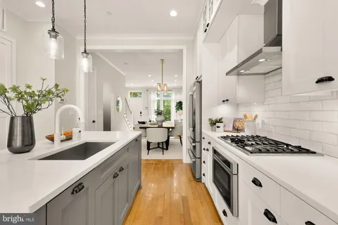 a kitchen with sink stove and cabinets