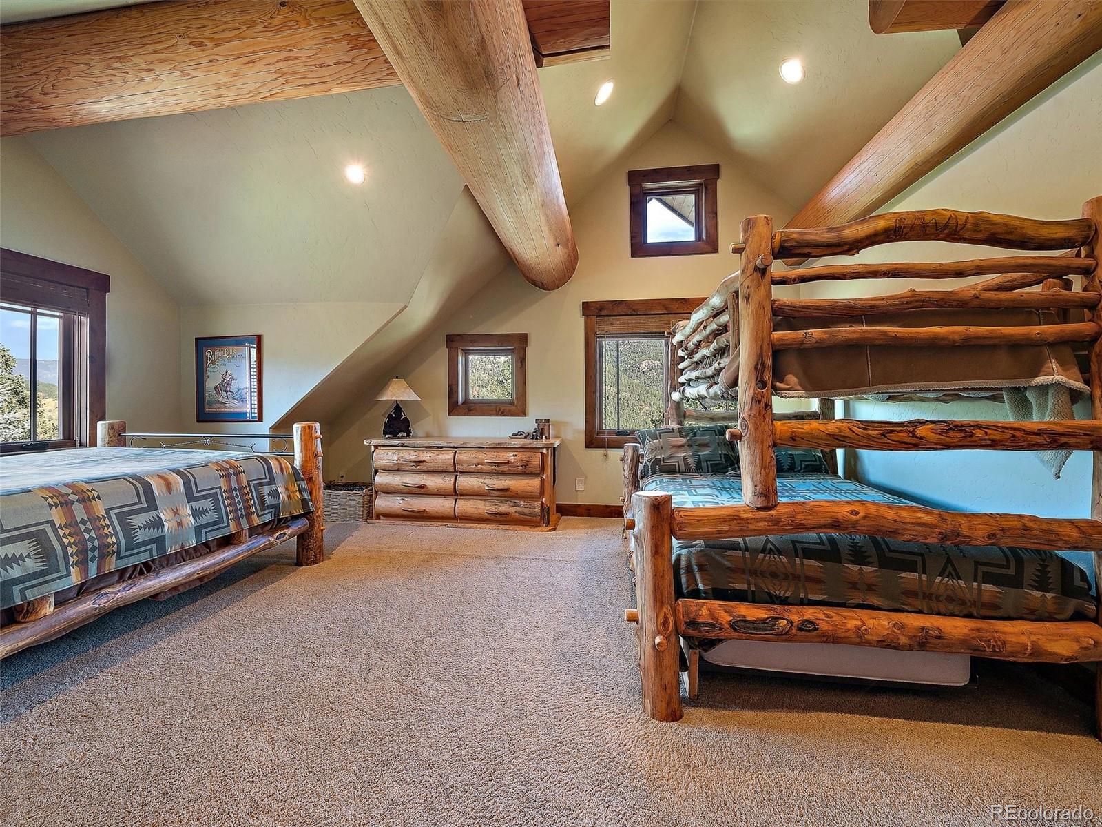 451 Bear Meadow Trail Evergreen, CO 80439 - Photo 17 of 45 a bedroom with furniture and a window