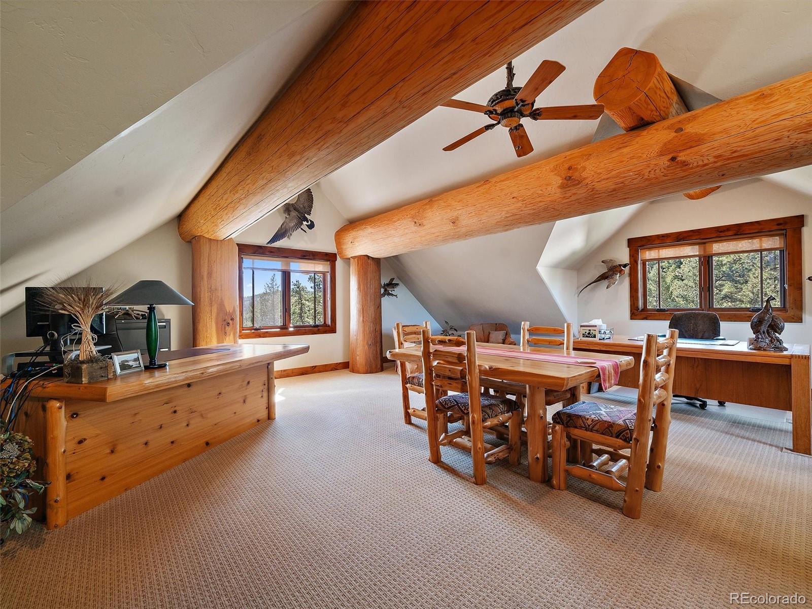 451 Bear Meadow Trail Evergreen, CO 80439 - Photo 20 of 45 a living room with furniture and a large window