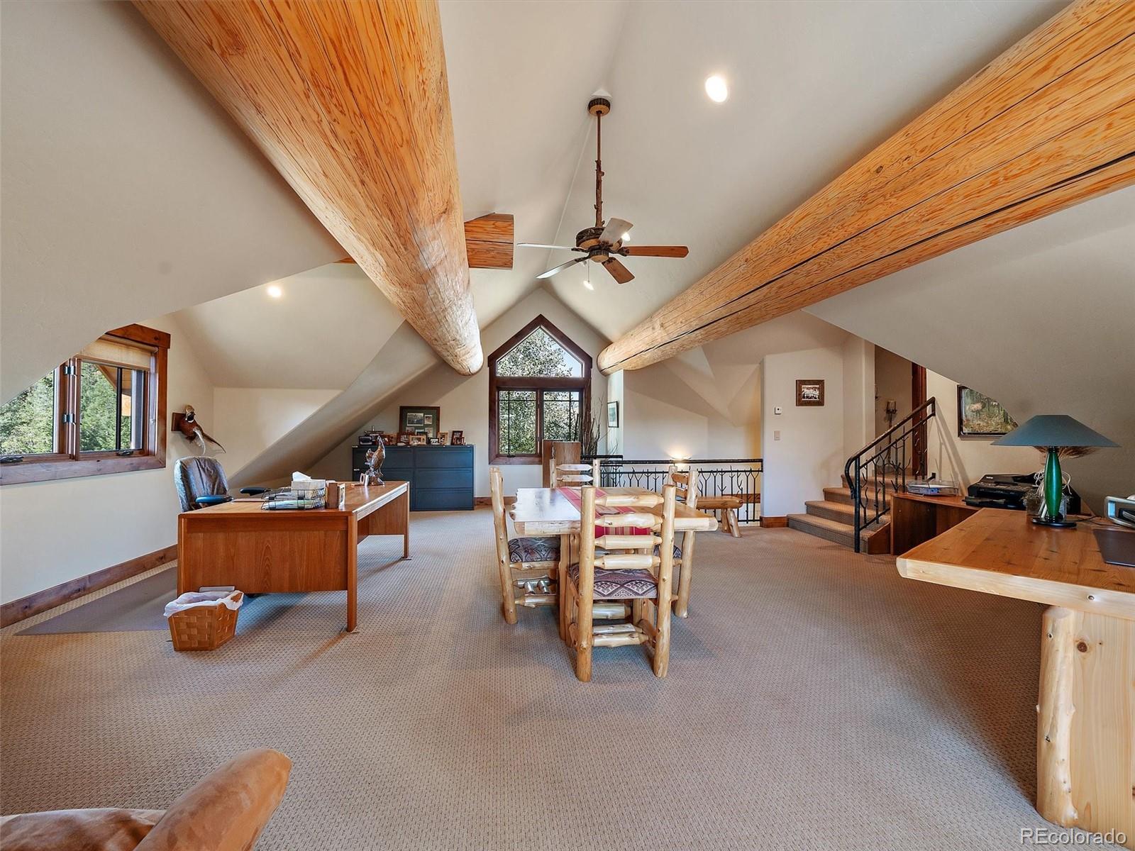 451 Bear Meadow Trail Evergreen, CO 80439 - Photo 21 of 45 a living room with furniture and a chandelier