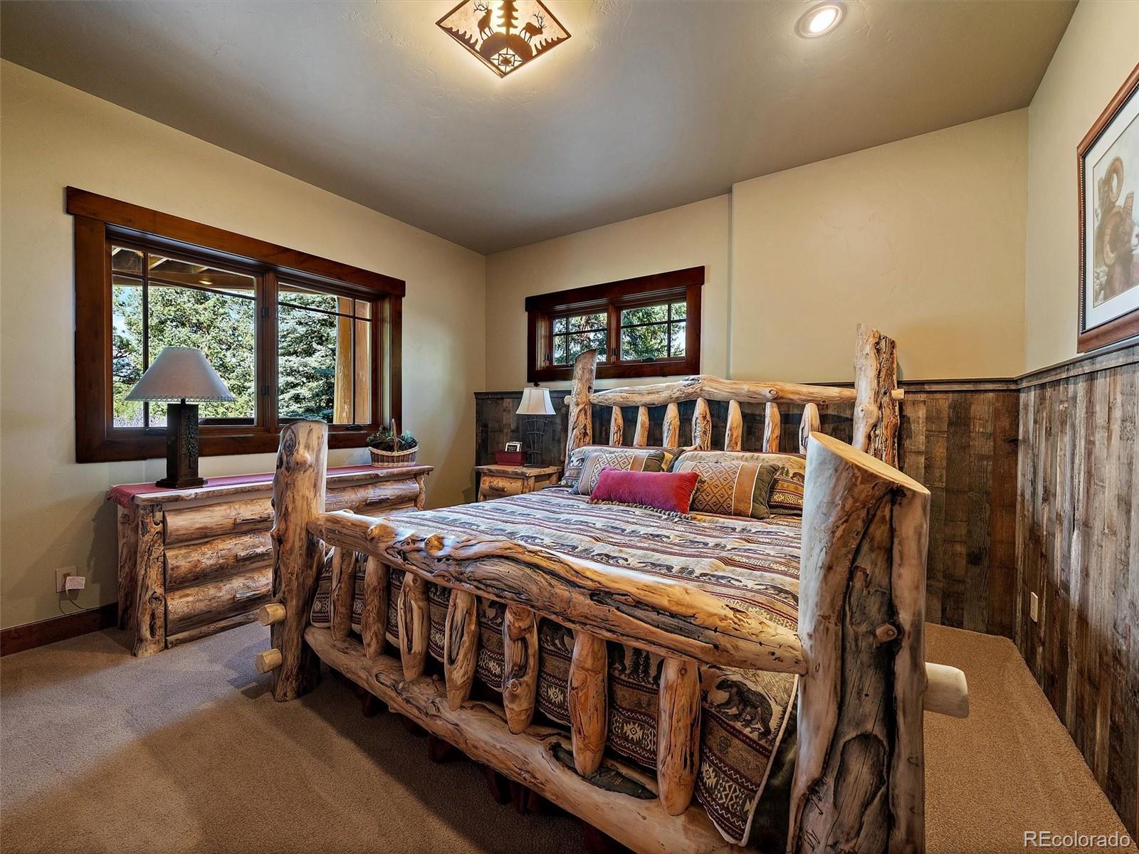 451 Bear Meadow Trail Evergreen, CO 80439 - Photo 24 of 45 a bedroom with a bed next to a large window