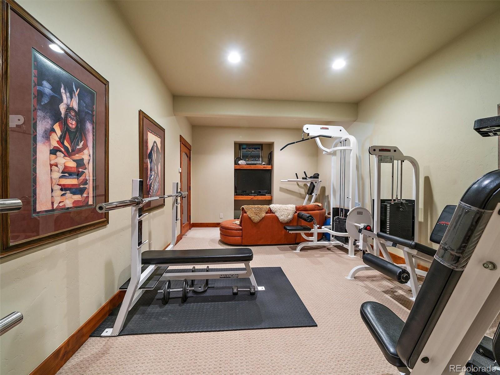 451 Bear Meadow Trail Evergreen, CO 80439 - Photo 27 of 45 a room with gym equipment and large mirror