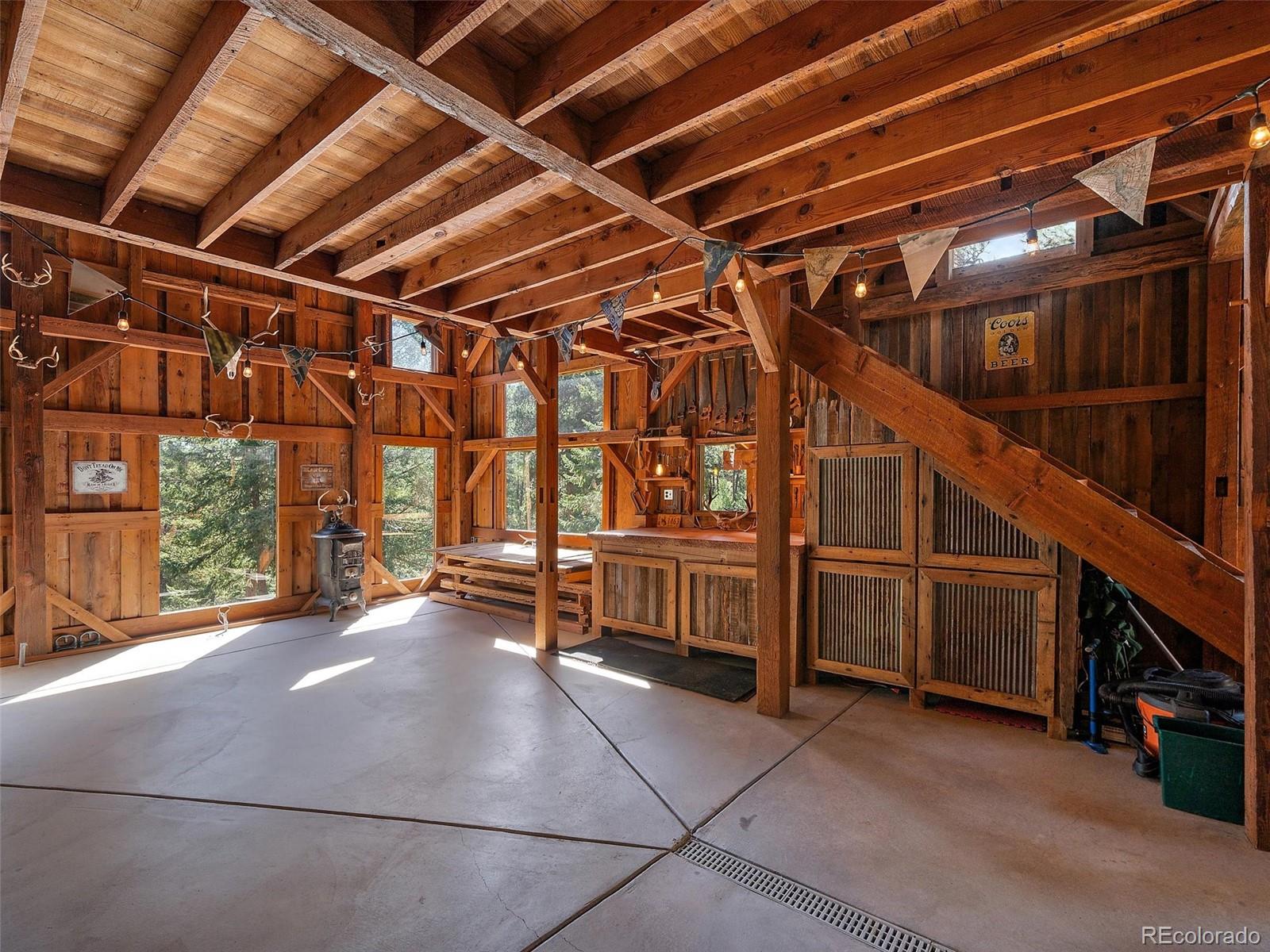 451 Bear Meadow Trail Evergreen, CO 80439 - Photo 37 of 45 a view of an empty room with wooden walls