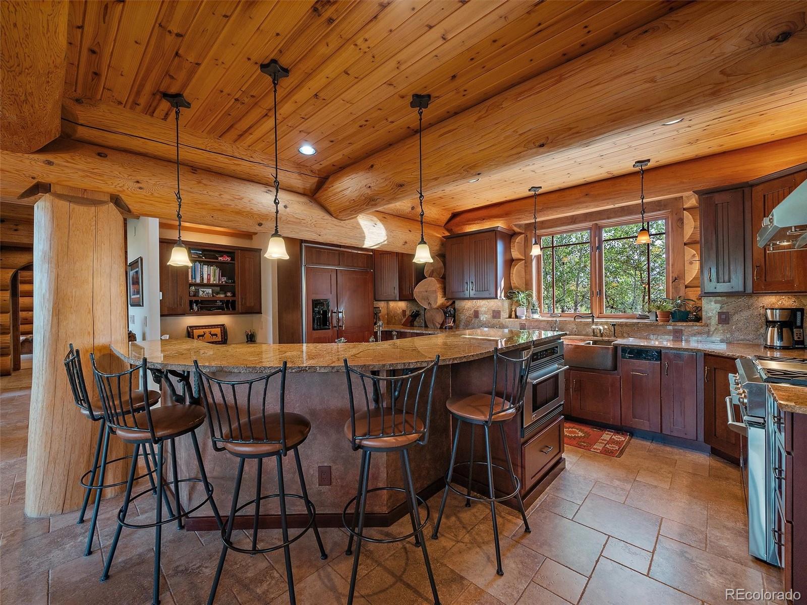 451 Bear Meadow Trail Evergreen, CO 80439 - Photo 6 of 45 a view of a dining room with furniture window and outside view