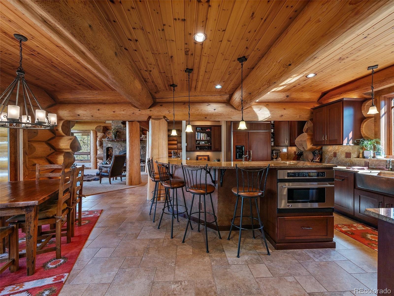 451 Bear Meadow Trail Evergreen, CO 80439 - Photo 7 of 45 a kitchen with stainless steel appliances granite countertop a stove and a refrigerator