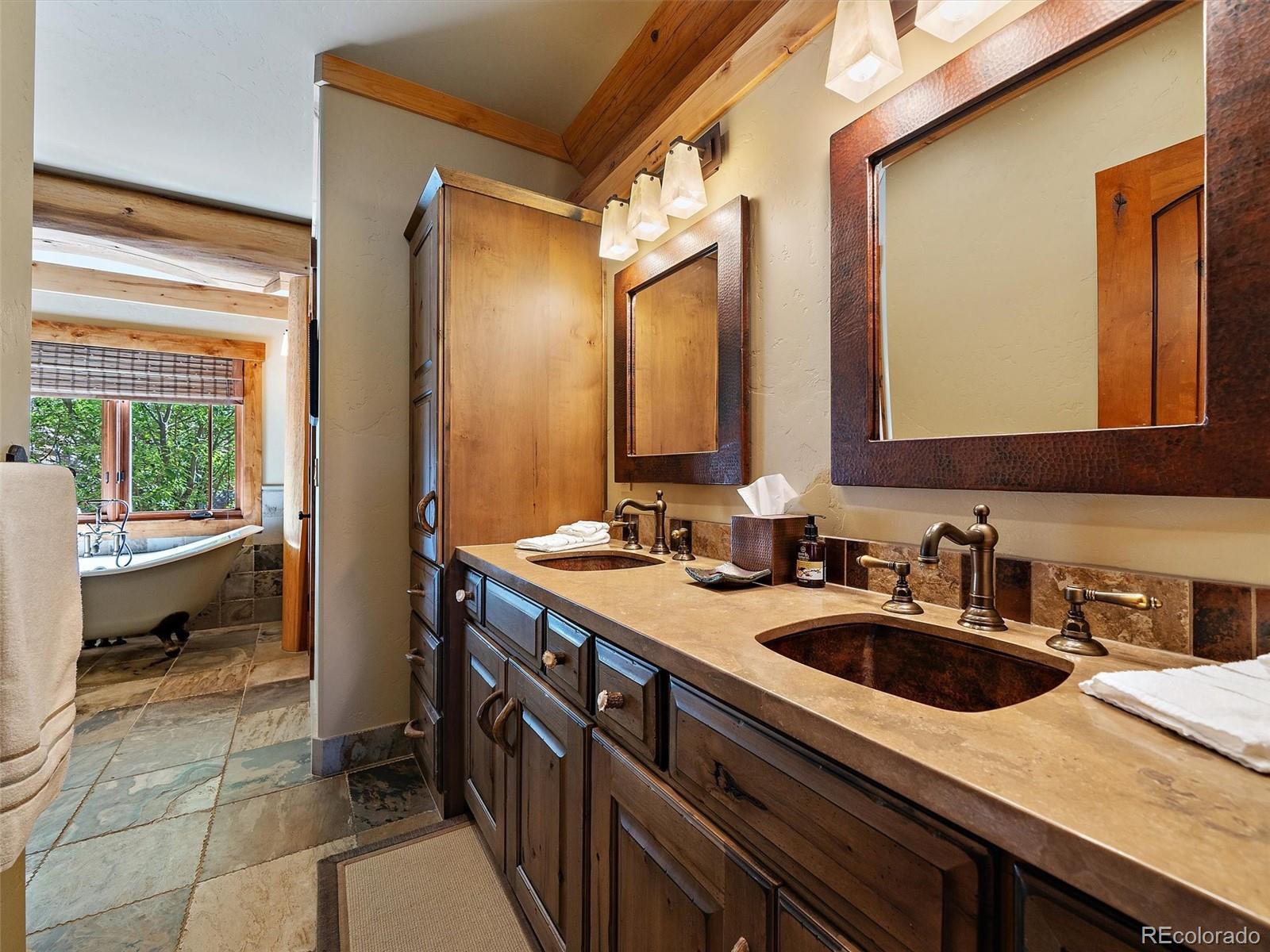 451 Bear Meadow Trail Evergreen, CO 80439 - Photo 10 of 45 a bathroom with a sink and a bathtub