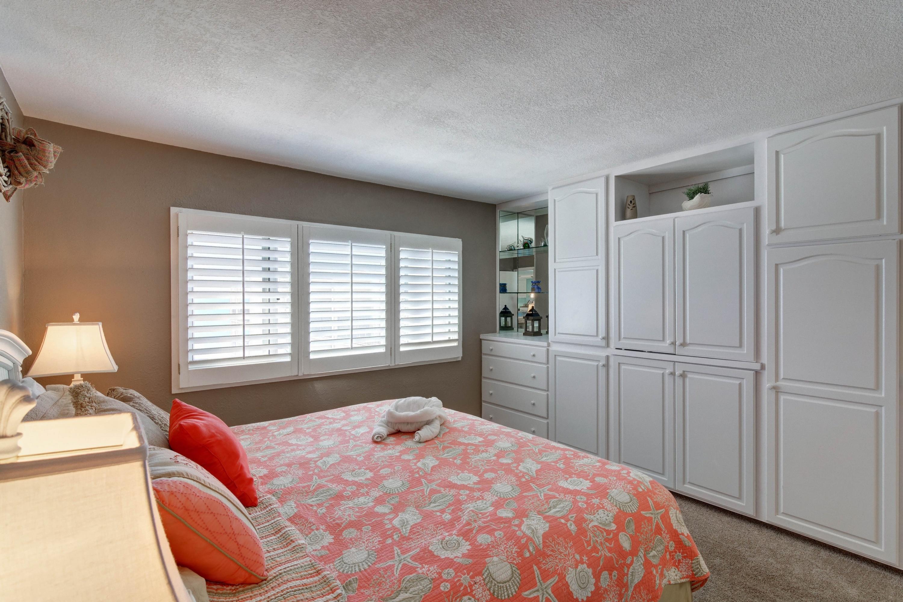 23223 Front Beach Road, Unit 701 Panama City Beach, FL 32413 - Photo 18 of 42 a bedroom with a bed and a cabinets