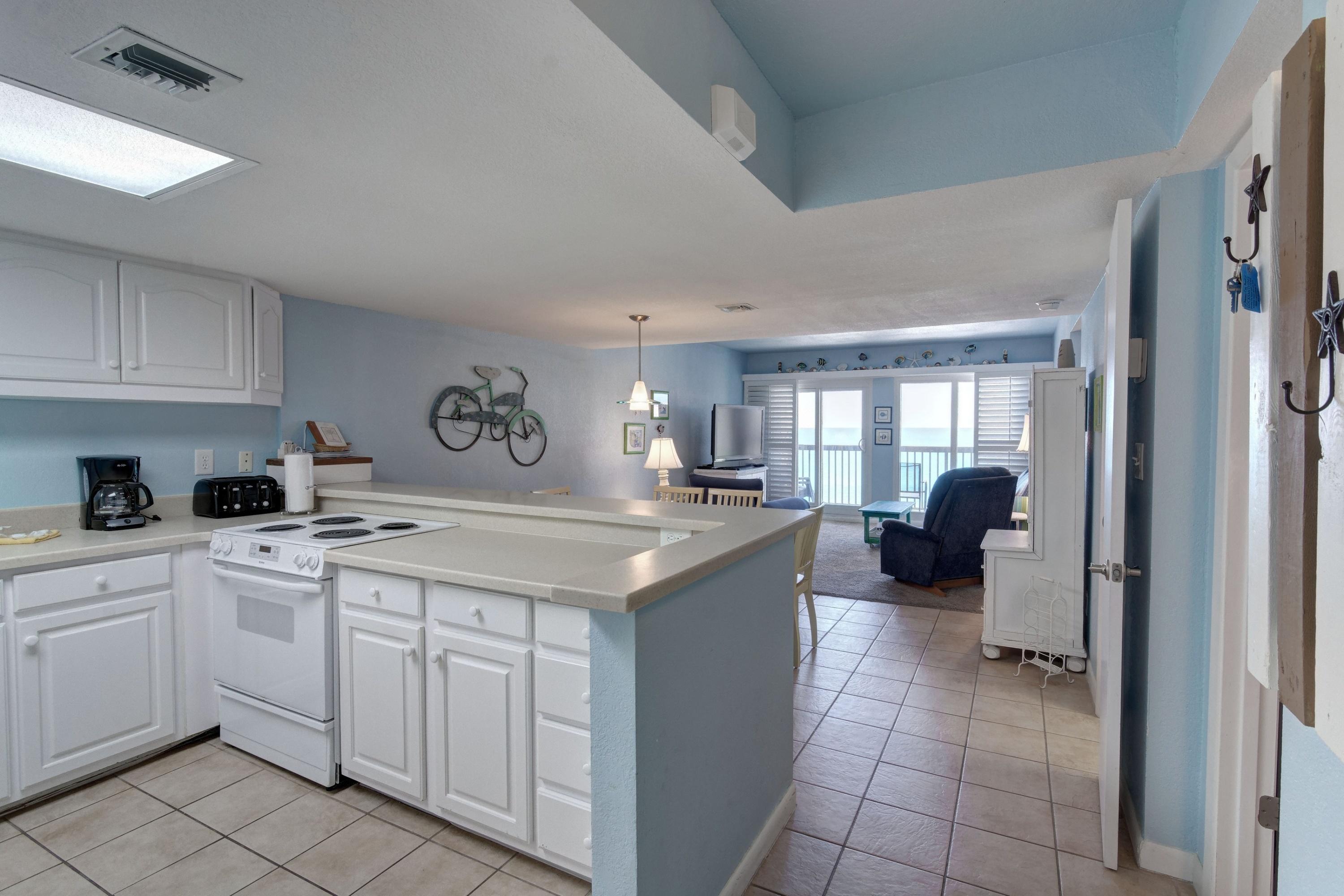 23223 Front Beach Road, Unit 701 Panama City Beach, FL 32413 - Photo 2 of 42 a kitchen with a sink and cabinets