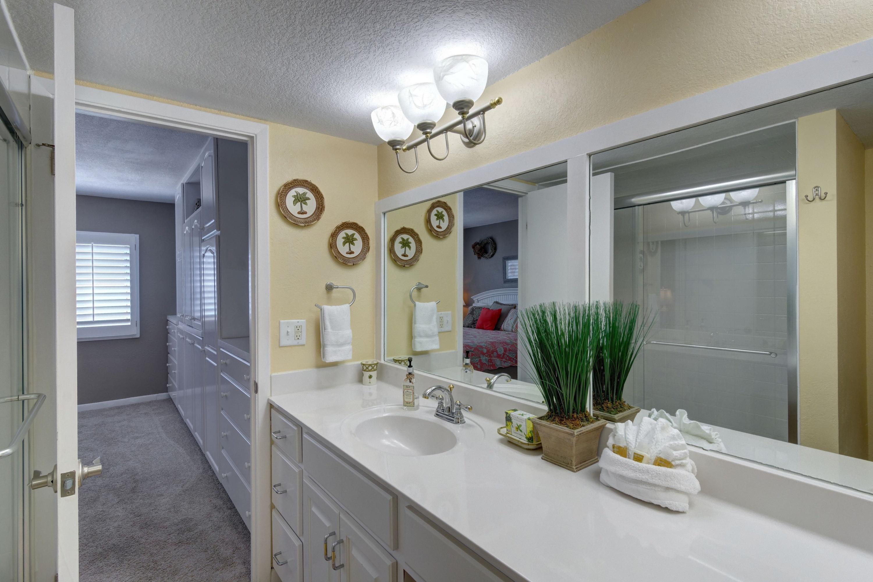 23223 Front Beach Road, Unit 701 Panama City Beach, FL 32413 - Photo 22 of 42 a bathroom with a sink vanity and a mirror