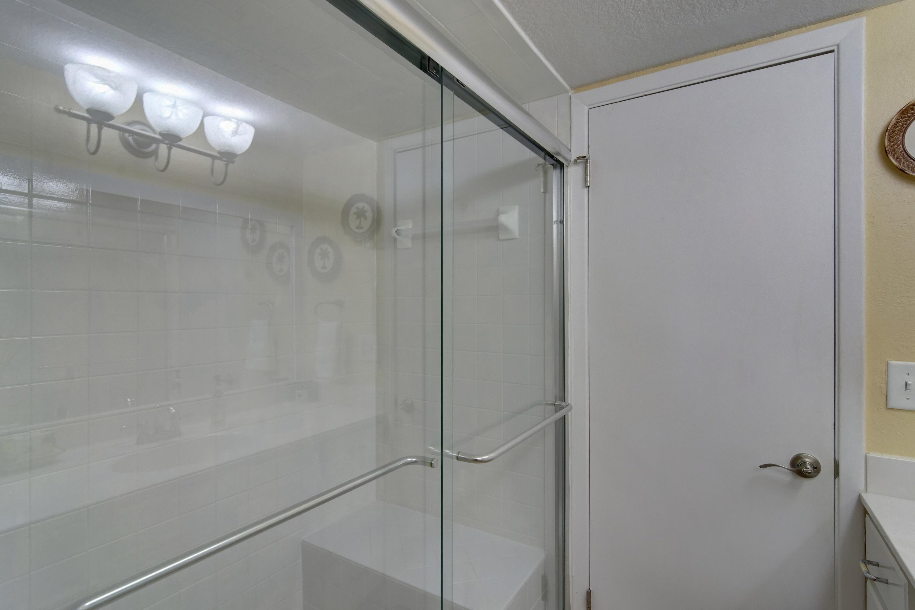 23223 Front Beach Road, Unit 701 Panama City Beach, FL 32413 - Photo 23 of 42 a bathroom with a glass shower door