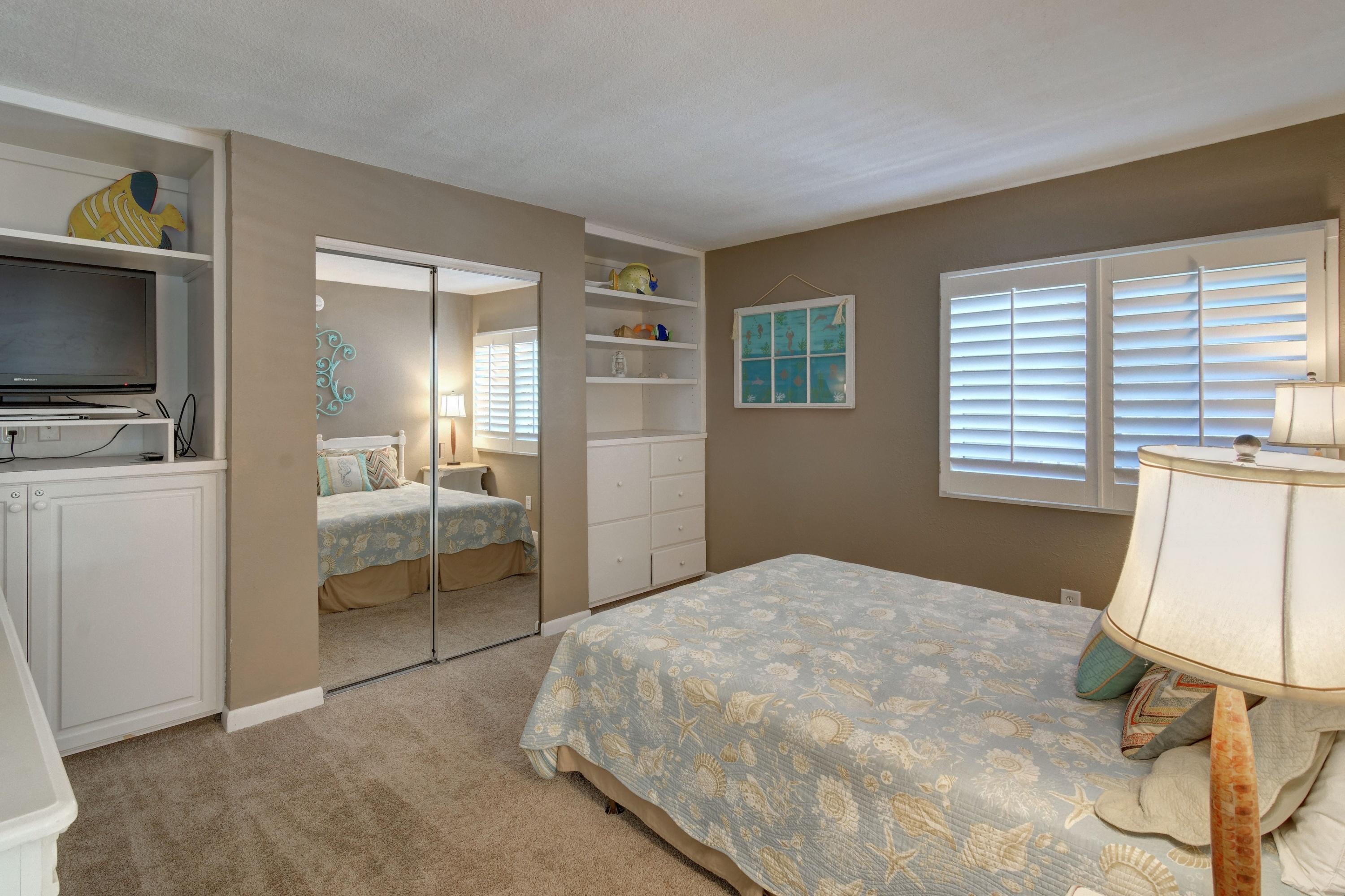 23223 Front Beach Road, Unit 701 Panama City Beach, FL 32413 - Photo 24 of 42 a bedroom with a bed and a television in it