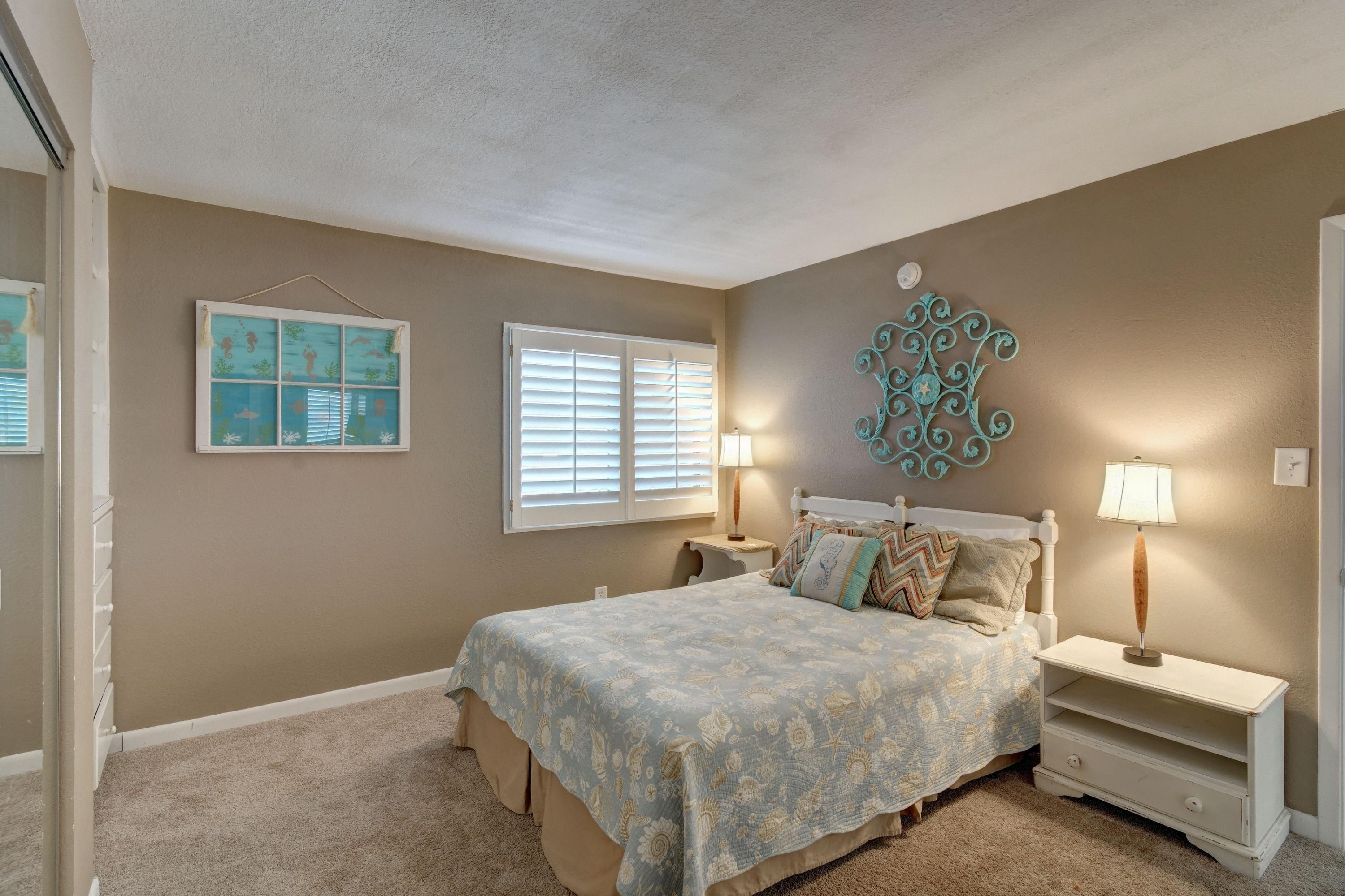 23223 Front Beach Road, Unit 701 Panama City Beach, FL 32413 - Photo 25 of 42 a bedroom with a bed and a lamp