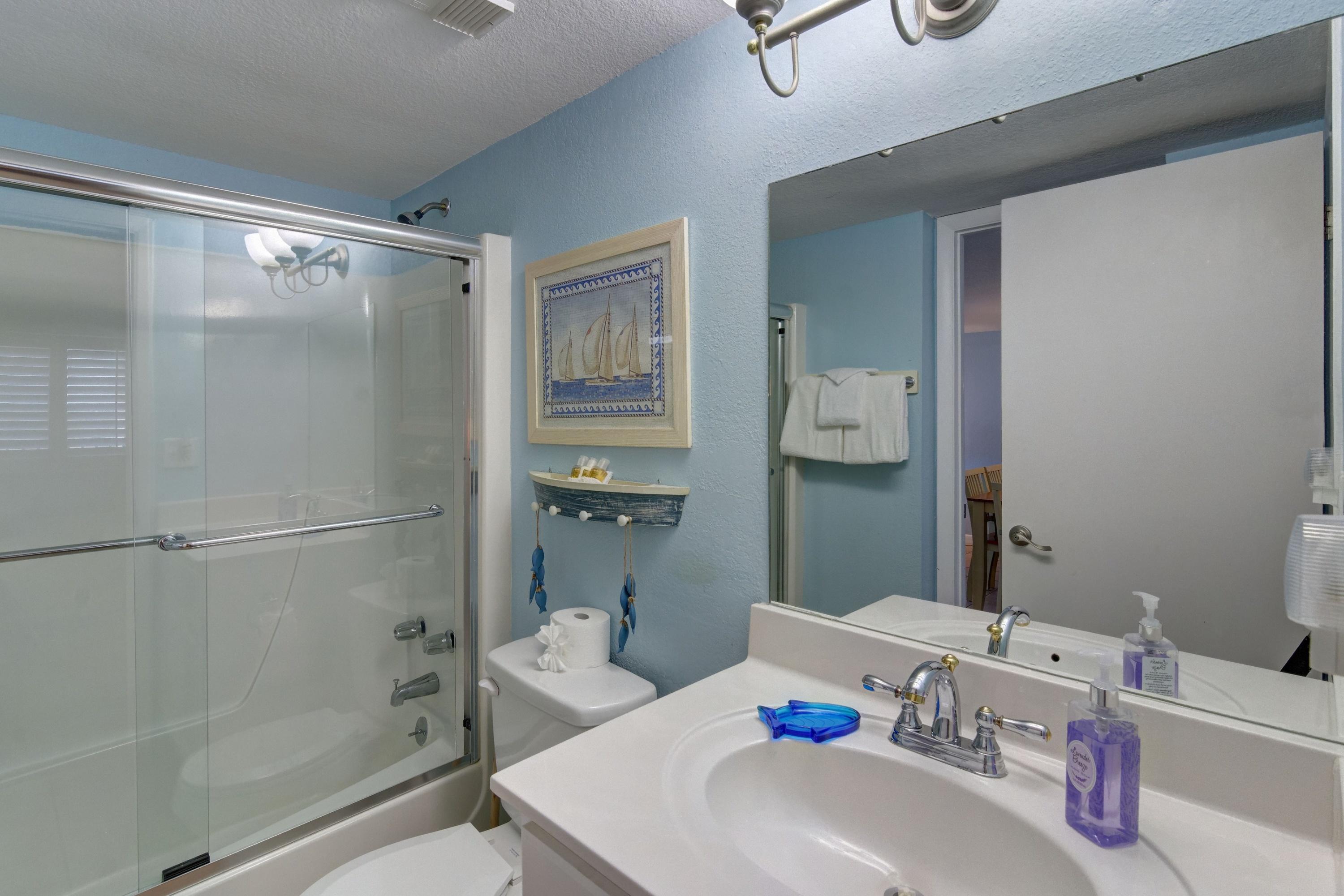 23223 Front Beach Road, Unit 701 Panama City Beach, FL 32413 - Photo 27 of 42 a bathroom with a sink mirror and shower