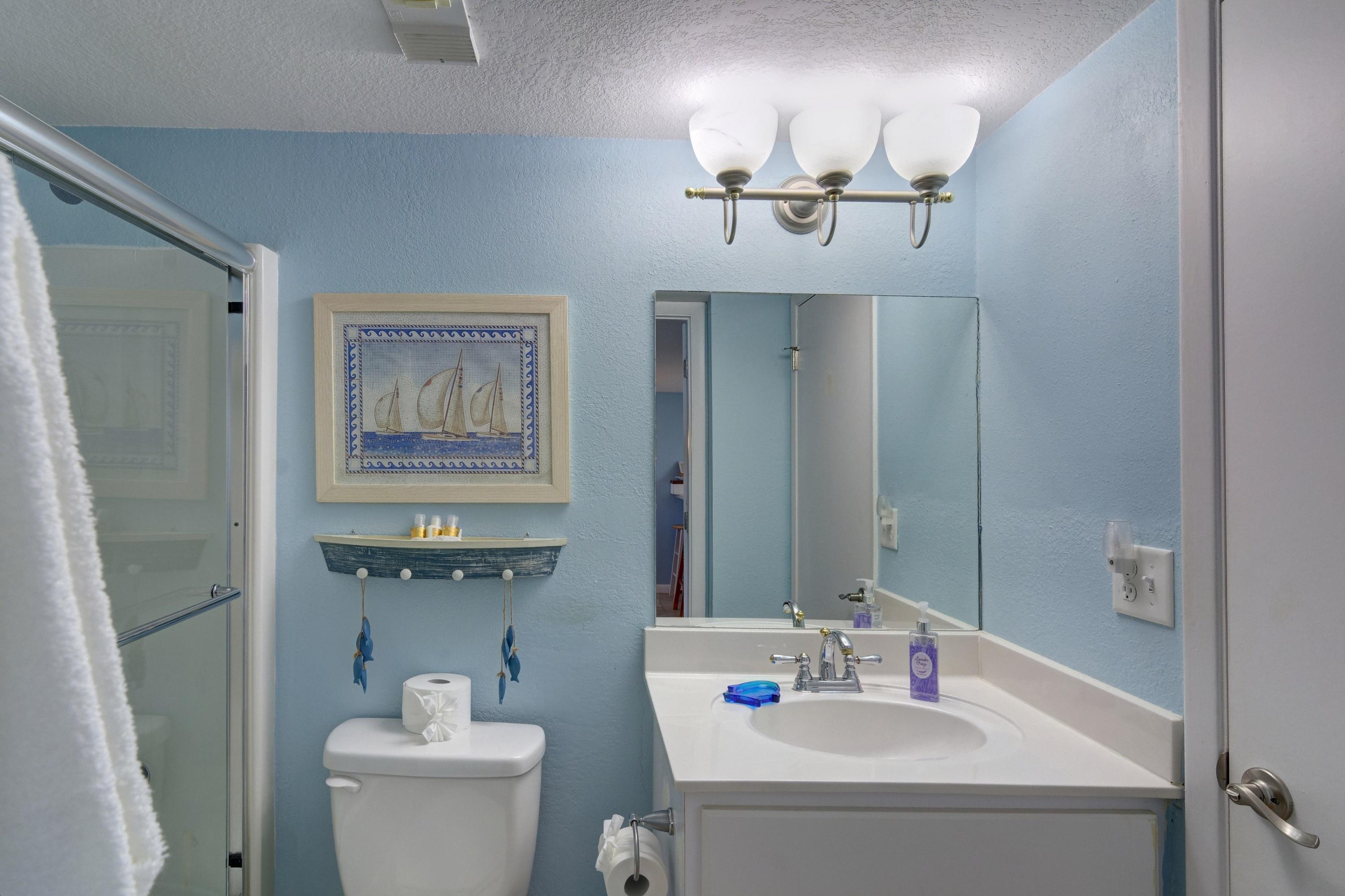 23223 Front Beach Road, Unit 701 Panama City Beach, FL 32413 - Photo 28 of 42 a bathroom with a sink and mirror with toilet