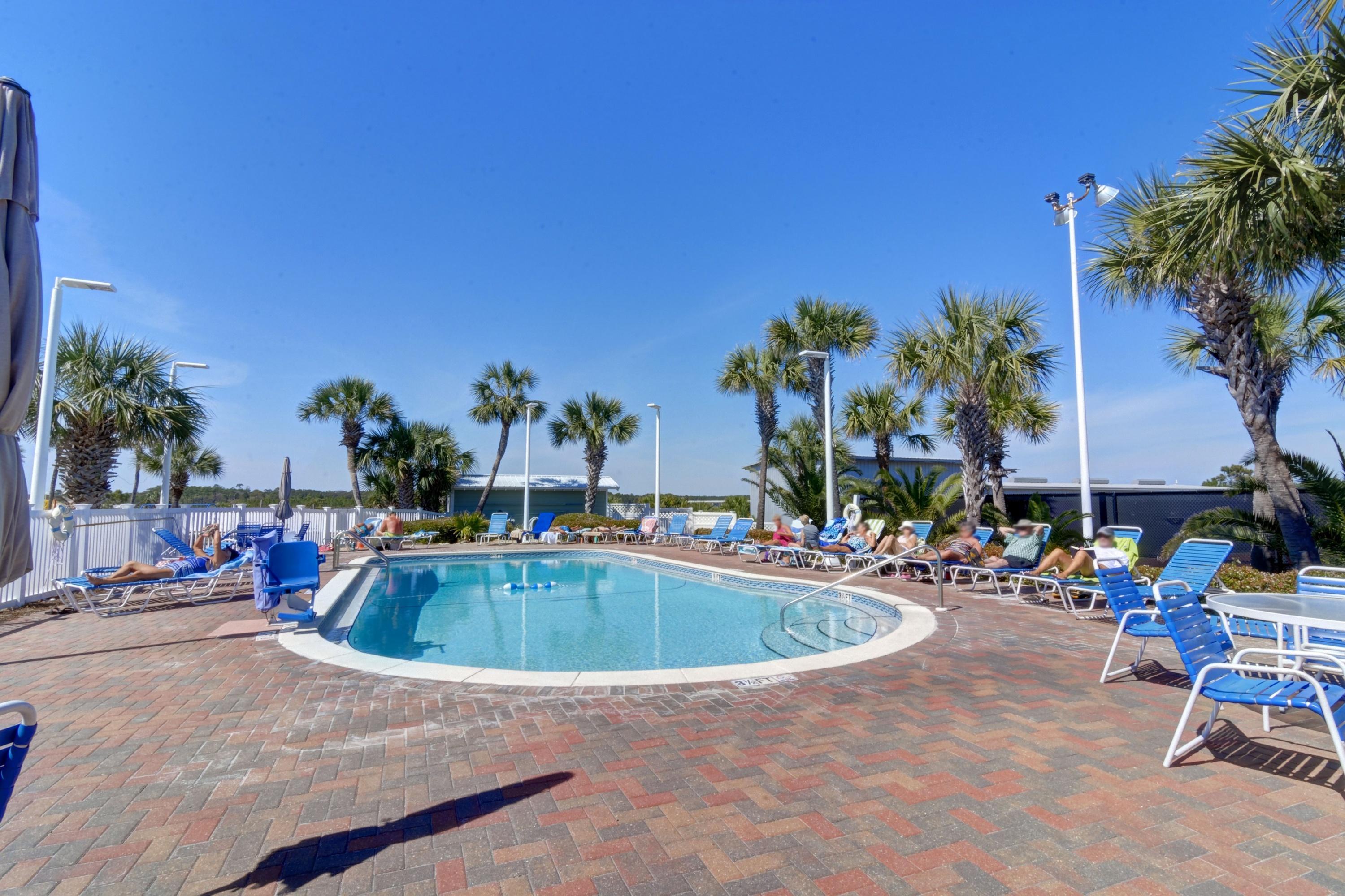 23223 Front Beach Road, Unit 701 Panama City Beach, FL 32413 - Photo 29 of 42 a swimming pool with outdoor seating and yard