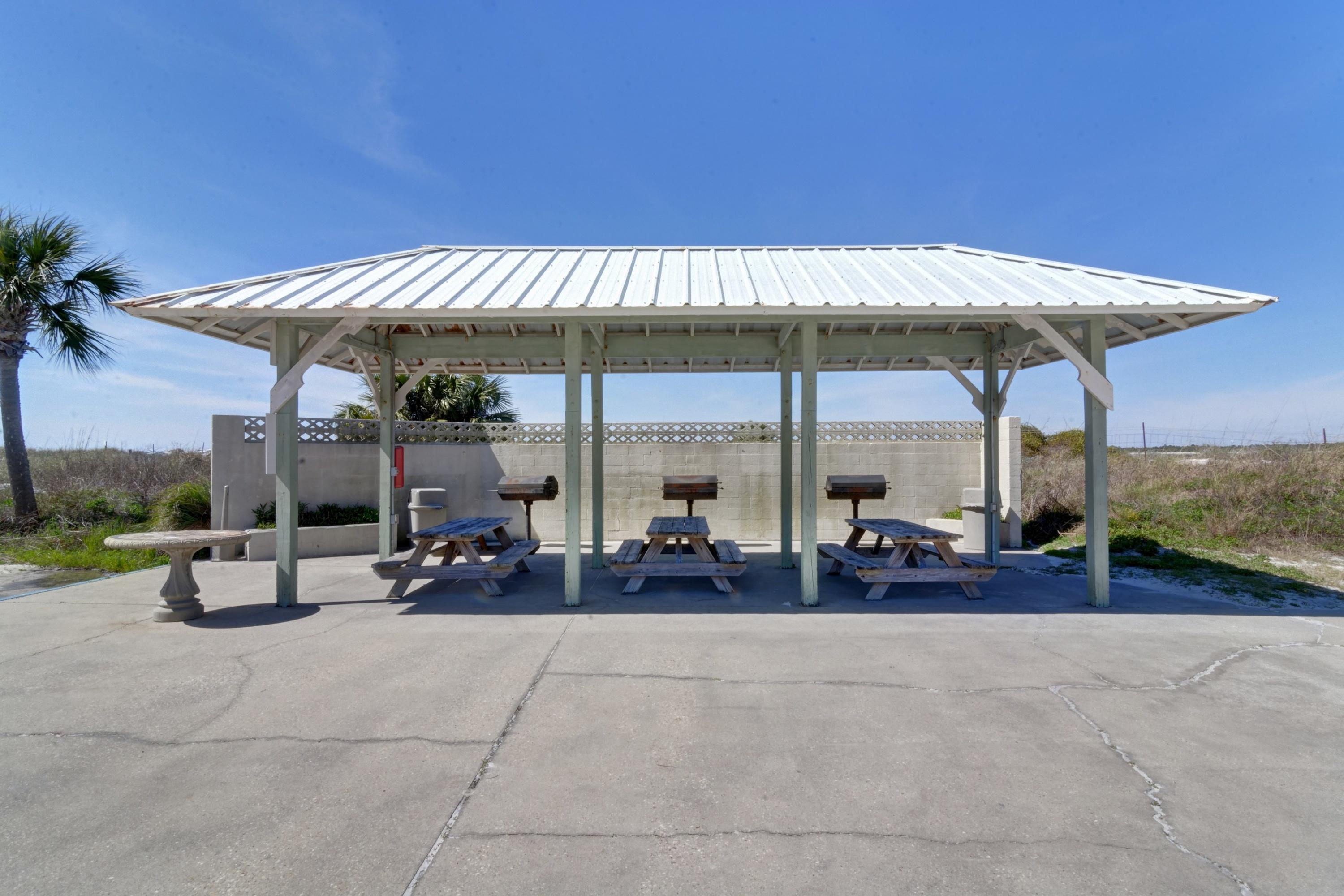23223 Front Beach Road, Unit 701 Panama City Beach, FL 32413 - Photo 38 of 42 a view of a patio with a table and chairs under an umbrella