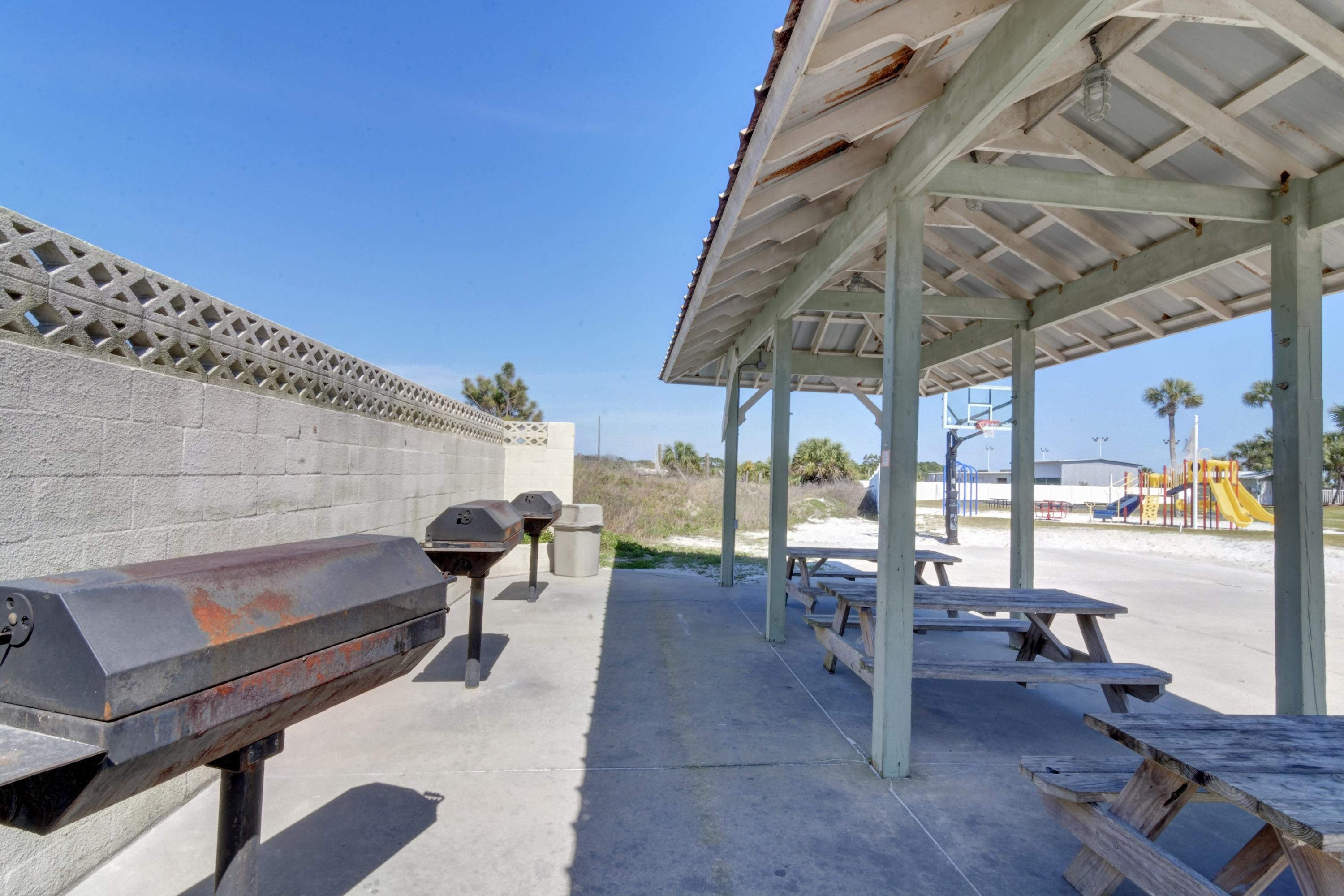 23223 Front Beach Road, Unit 701 Panama City Beach, FL 32413 - Photo 39 of 42 a view of a patio with a table and chairs