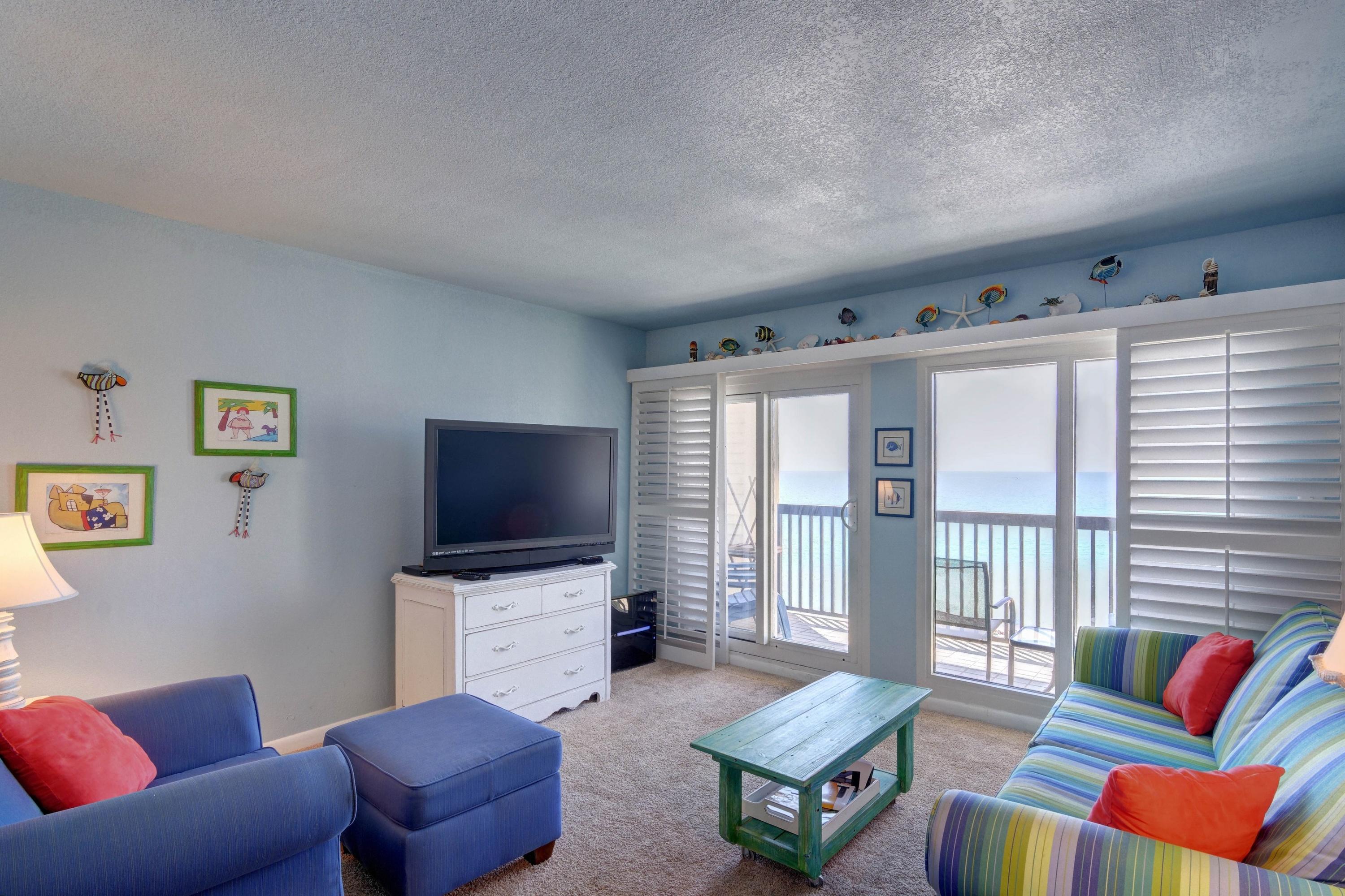 23223 Front Beach Road, Unit 701 Panama City Beach, FL 32413 - Photo 9 of 42 a living room with furniture and a flat screen tv