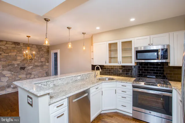 a kitchen with a refrigerator sink and stove
