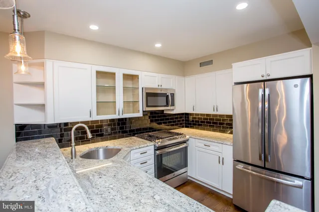 a view of a kitchen with a sink and dishwasher wooden floor
