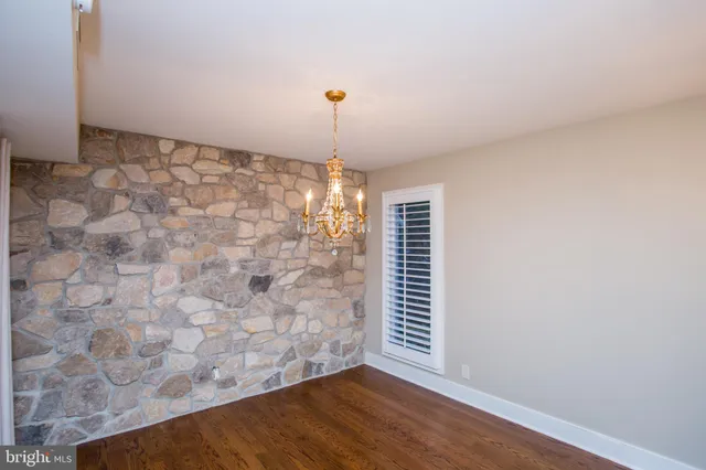 a view of a kitchen with a table & chairs