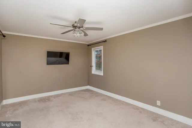 a view of a livingroom with a ceiling fan and window