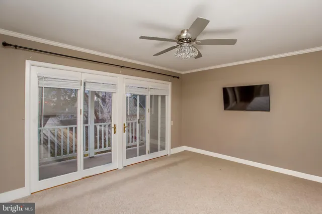 a view of a livingroom with a ceiling fan and window