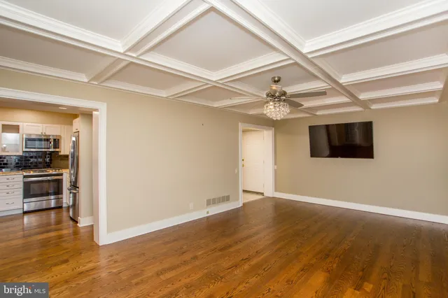 a kitchen with stainless steel appliances granite countertop a refrigerator sink and stove