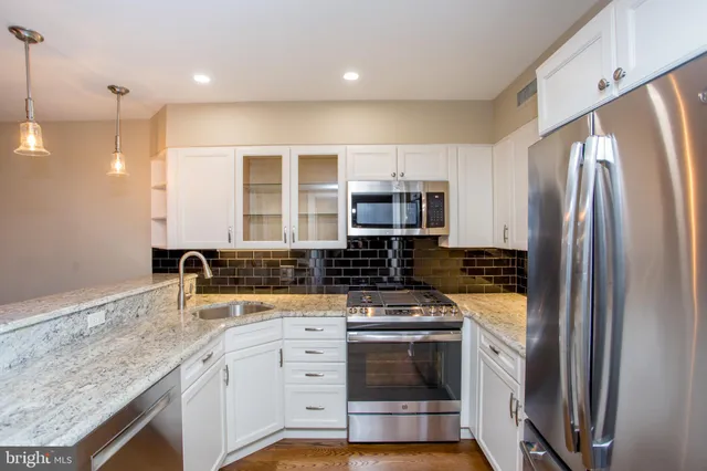 a kitchen with a stove and a sink