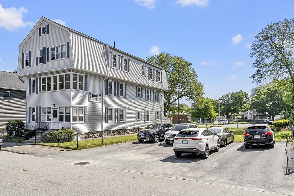 a car parked in front of a white house