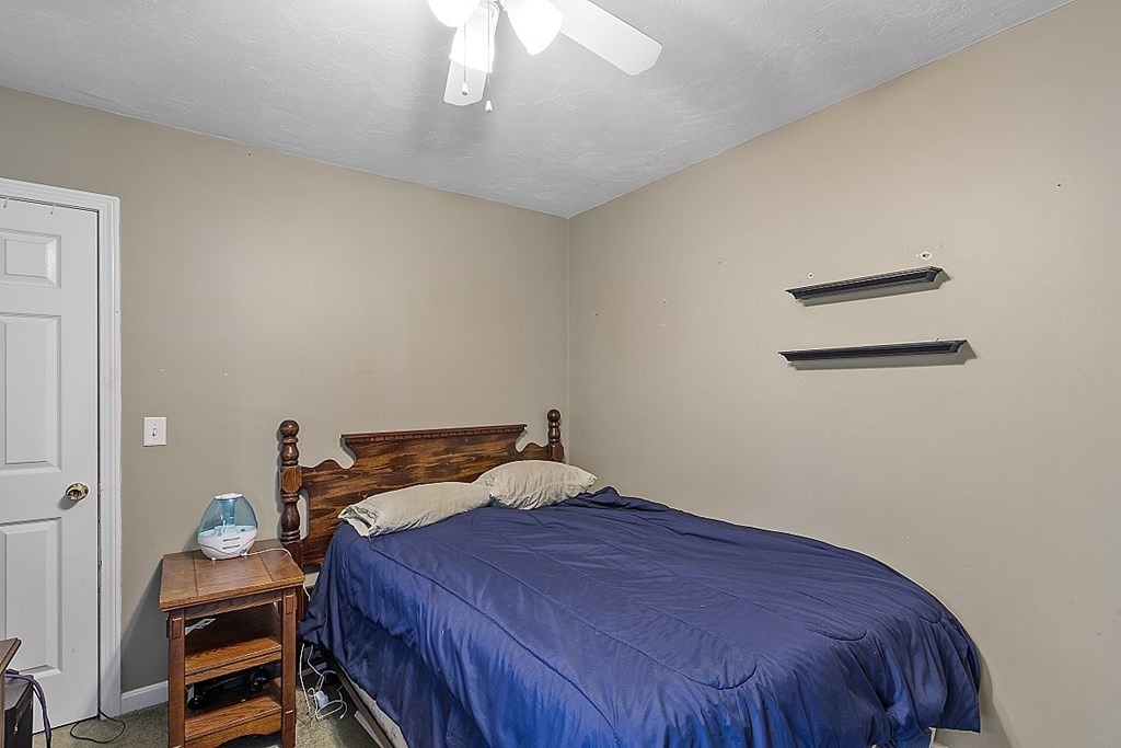 57 Vale Street Worcester, MA 01604 - Photo 13 of 39 a bedroom with a bed and a chandelier