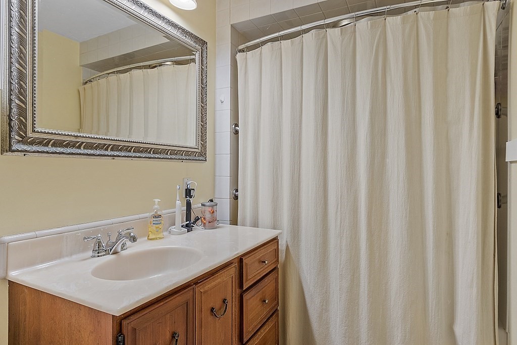 57 Vale Street Worcester, MA 01604 - Photo 17 of 39 a bathroom with a sink and a mirror
