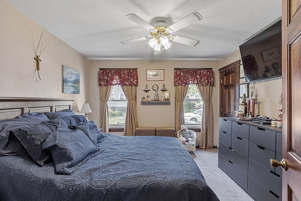 57 Vale Street Worcester, MA 01604 - Photo 18 of 39 a spacious bedroom with a bed and a chandelier