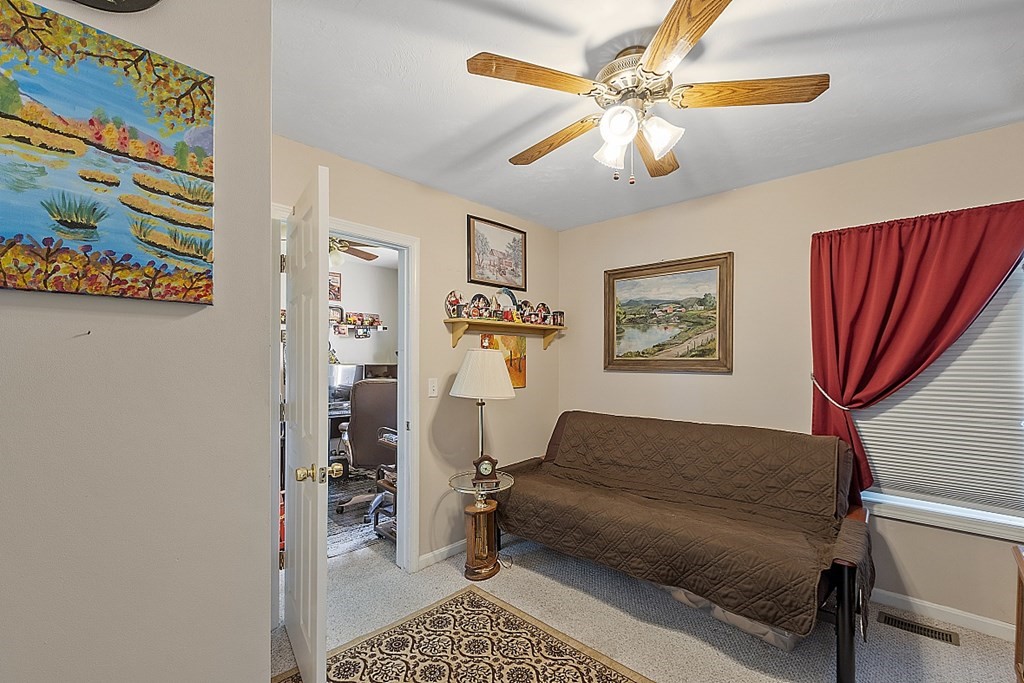 57 Vale Street Worcester, MA 01604 - Photo 21 of 39 a living room with furniture and a chandelier