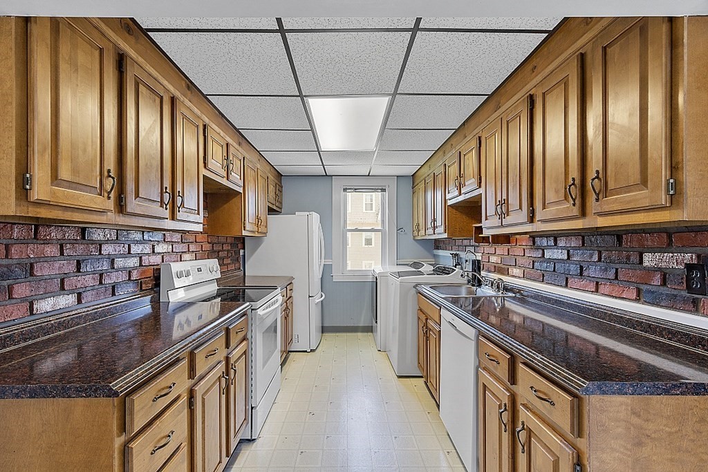 57 Vale Street Worcester, MA 01604 - Photo 25 of 39 a kitchen with stainless steel appliances granite countertop a stove a sink dishwasher and cabinets with wooden floor