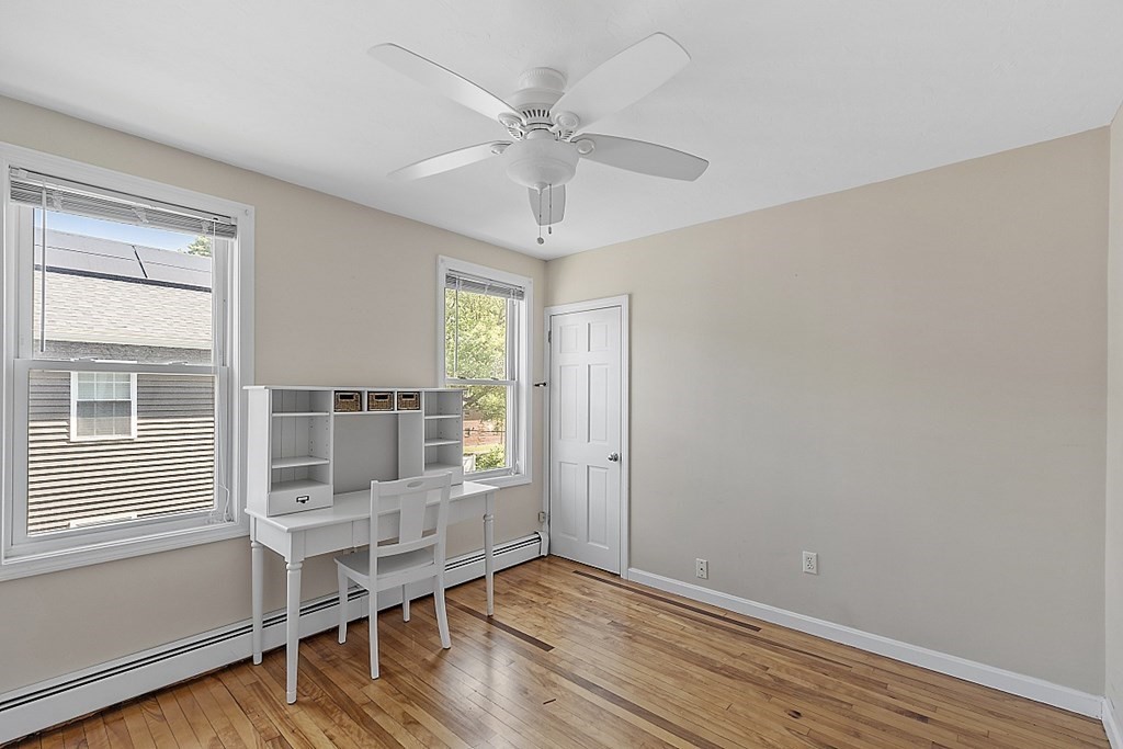 57 Vale Street Worcester, MA 01604 - Photo 29 of 39 an empty room with wooden floor fan and windows