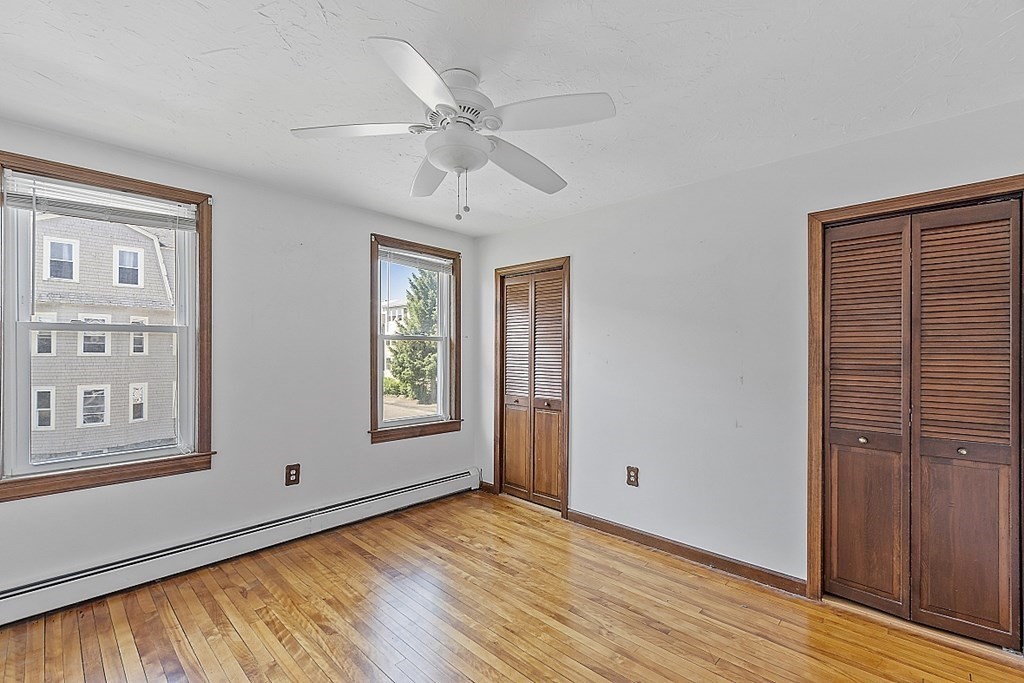 57 Vale Street Worcester, MA 01604 - Photo 34 of 39 a view of an empty room with wooden floor and a window