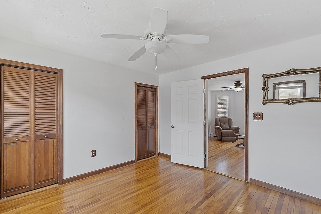 57 Vale Street Worcester, MA 01604 - Photo 36 of 39 a view of a livingroom with wooden floor and a ceiling fan