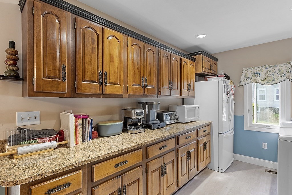 57 Vale Street Worcester, MA 01604 - Photo 4 of 39 a kitchen with stainless steel appliances granite countertop a sink and a refrigerator