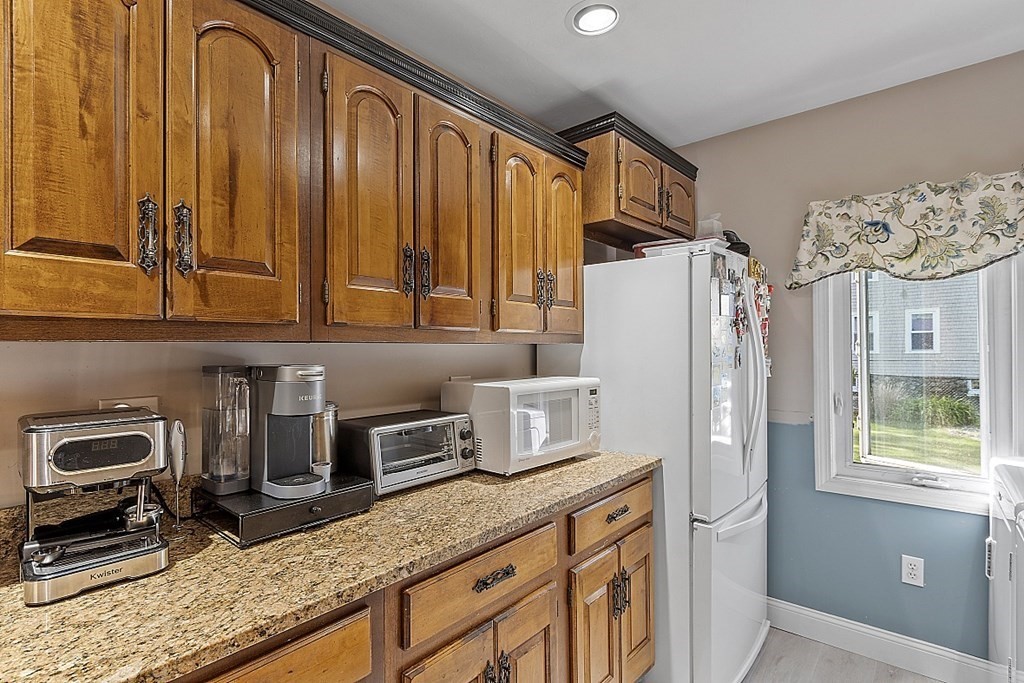 57 Vale Street Worcester, MA 01604 - Photo 6 of 39 a kitchen with stainless steel appliances granite countertop a refrigerator and a sink