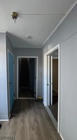 a view of a livingroom with an empty space and a window