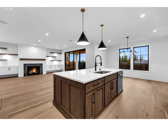 a kitchen with stainless steel appliances granite countertop a stove and a sink with wooden cabinets